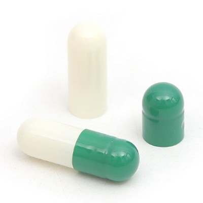 Closed green and white empty hard gelatin capsule shell size 0